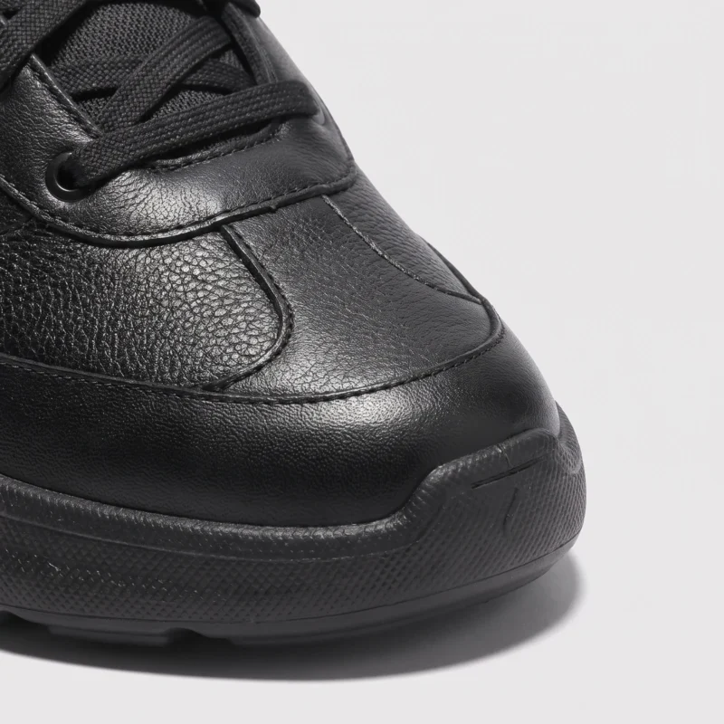 lightweight boa walking sneakers in black, close-up view of the toe on a light gray background