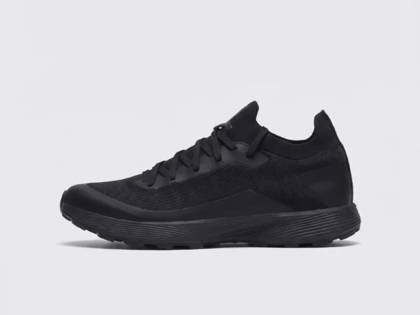 lightweight trail running sneakers in black, left side profile view on a light gray background