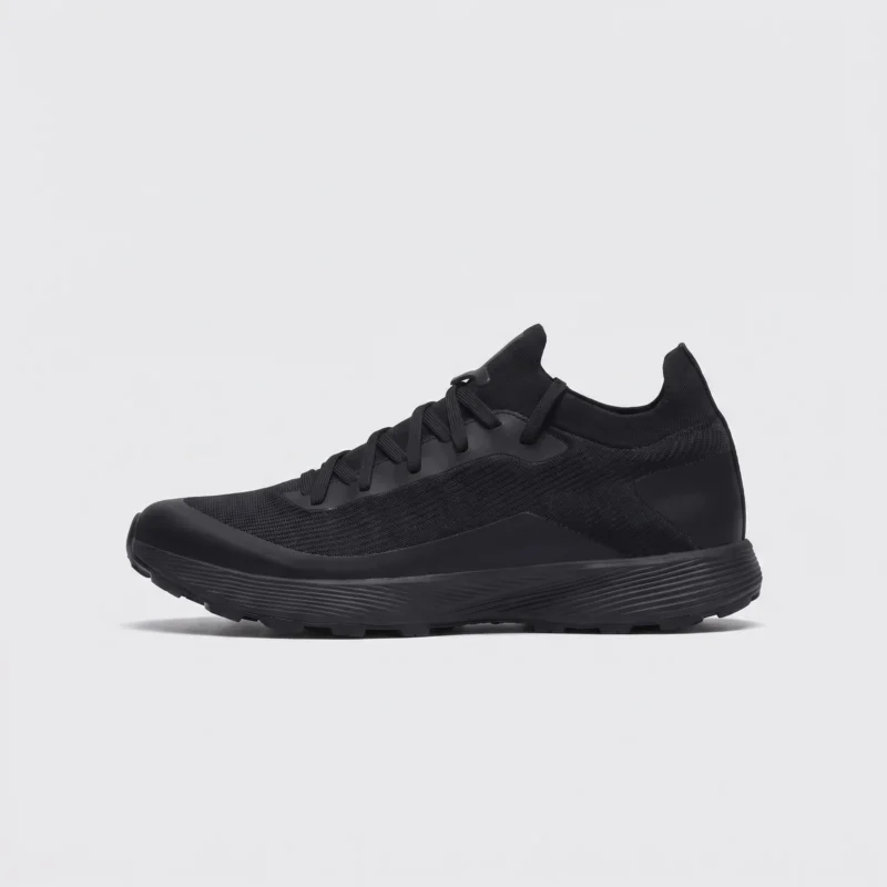 lightweight trail running sneakers in black, left side profile view on a light gray background