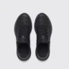 lightweight trail running sneakers in black, top-down view of the pair on a light gray background