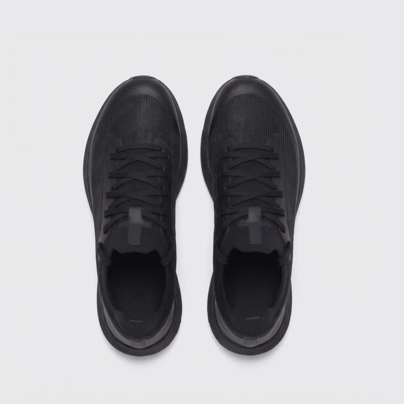 lightweight trail running sneakers in black, top-down view of the pair on a light gray background