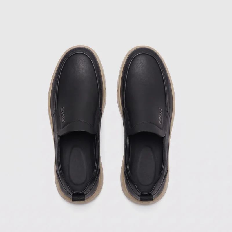 slip-on leather casual shoes in black, top-down view of the pair on a light gray background