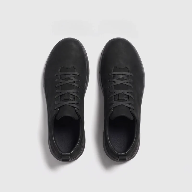 waterproof leather hiking sneakers in black, top-down view of the pair on a light gray background
