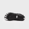 barefoot aqua water shoes quick-dry for beach wading hiking surfing in black, outsole tread view on a light gray background