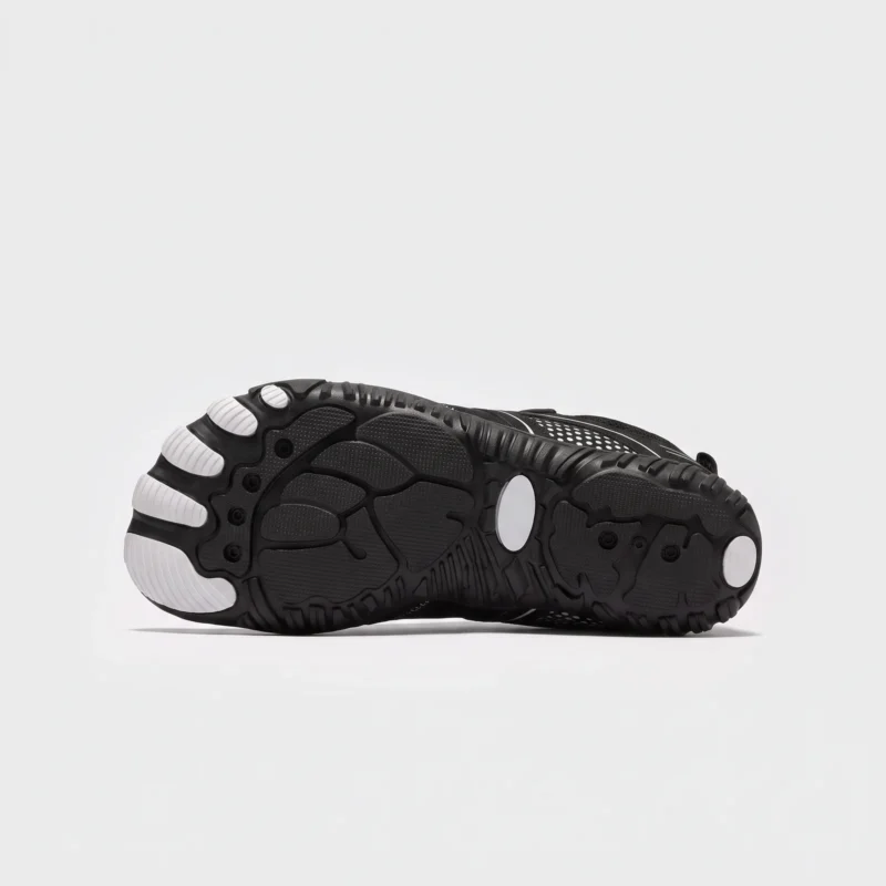 barefoot aqua water shoes quick-dry for beach wading hiking surfing in black, outsole tread view on a light gray background