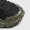 breathable mesh running sneakers lightweight chunky sole casual outdoor shoes in green, close-up view of the toe on a light gray background