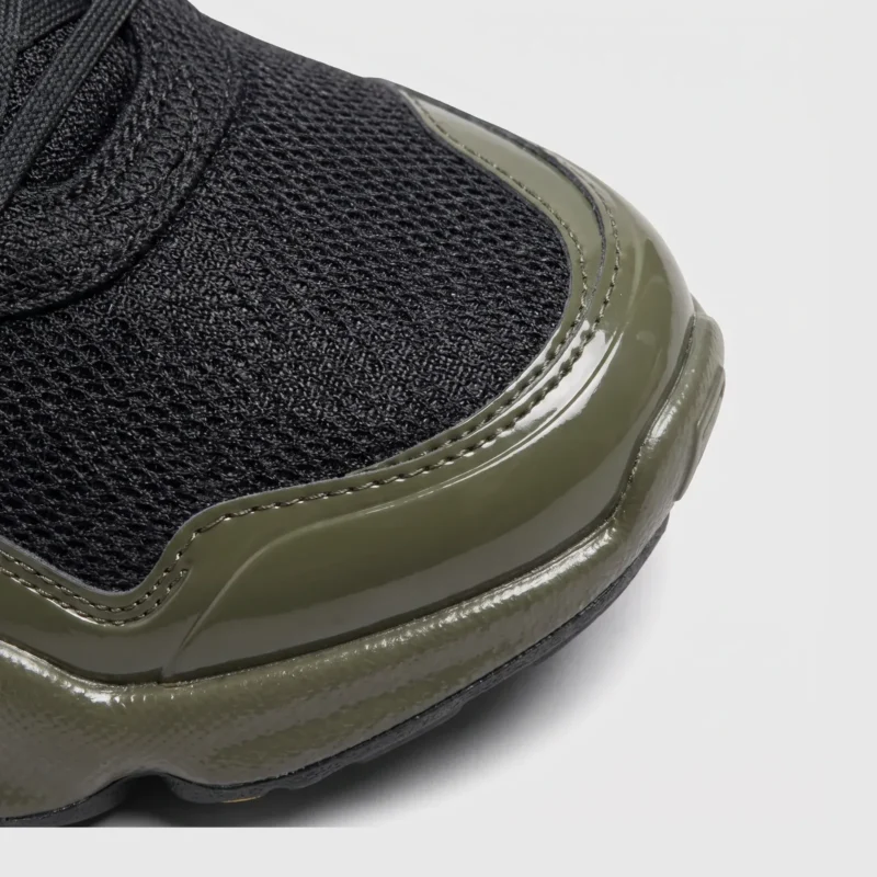 breathable mesh running sneakers lightweight chunky sole casual outdoor shoes in green, close-up view of the toe on a light gray background