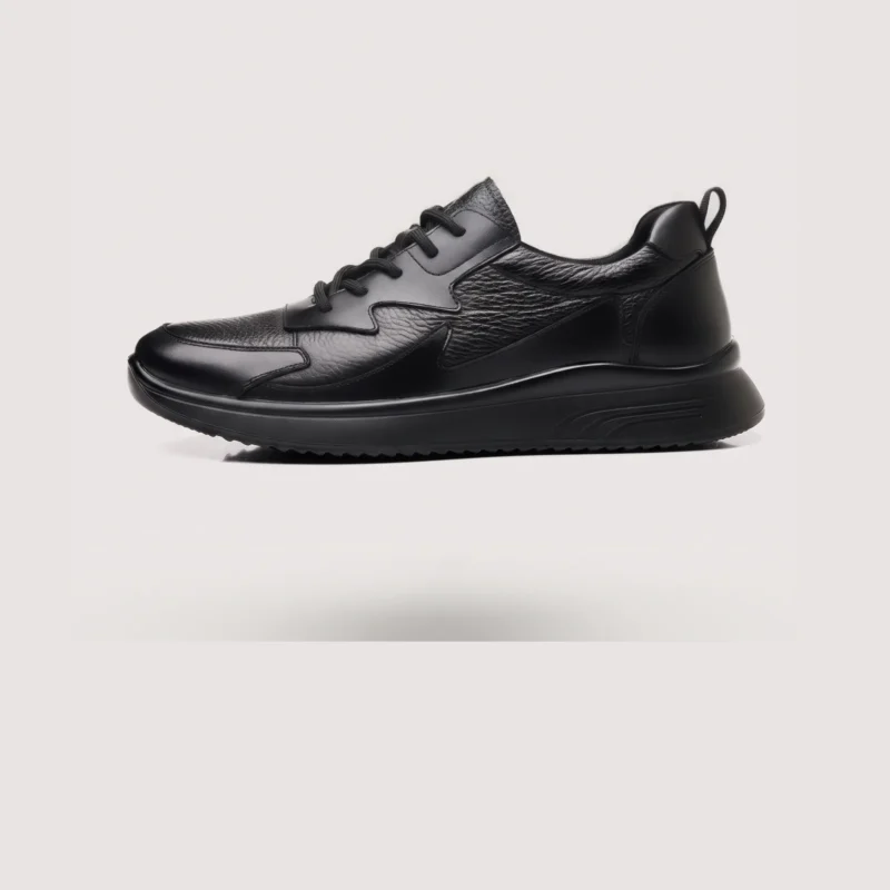 genuine leather casual shoes breathable lightweight non-slip walking sneakers in black, left side profile view on a light gray background