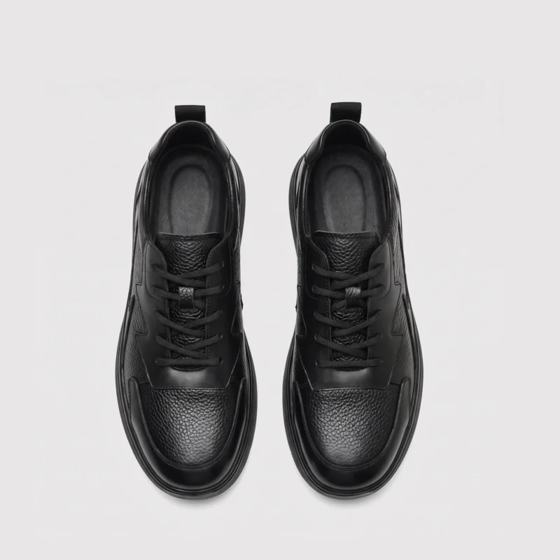 genuine leather casual shoes breathable lightweight non-slip walking sneakers in black, top-down view of the pair on a light gray background