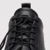 genuine leather lace-up casual sneakers warm comfortable in black, close-up view of the closure on a light gray background