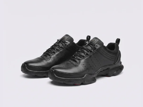 genuine leather business casual sneakers lightweight comfortable non-slip walking shoes in black, front 45-degree view of the pair on a light gray background