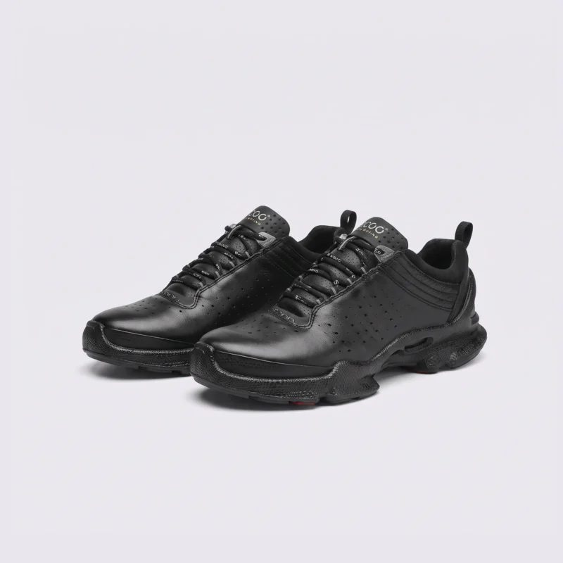 genuine leather business casual sneakers lightweight comfortable non-slip walking shoes in black, front 45-degree view of the pair on a light gray background
