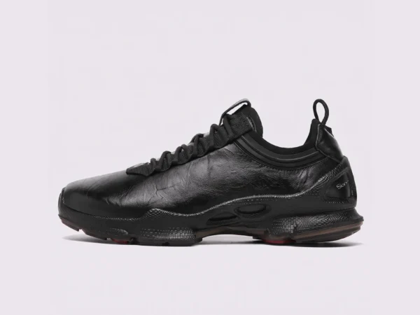 genuine leather business casual sneakers lightweight comfortable non-slip walking shoes in black, left side profile view on a light gray background