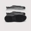 genuine leather business casual sneakers lightweight comfortable non-slip walking shoes in black, outsole tread view on a light gray background