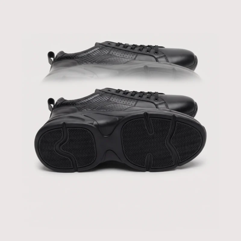genuine leather business casual sneakers lightweight comfortable non-slip walking shoes in black, outsole tread view on a light gray background