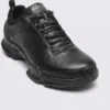 genuine leather business casual sneakers lightweight comfortable non-slip walking shoes in black, close-up view of the toe on a light gray background