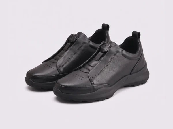genuine leather business casual running sneakers in black, front 45-degree view of the pair on a light gray background