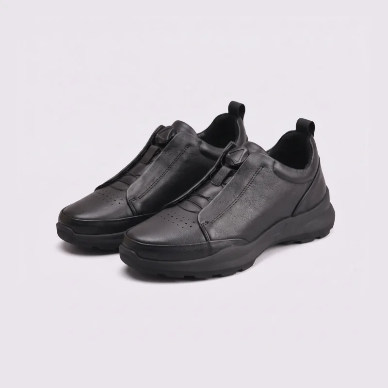 genuine leather business casual running sneakers in black, front 45-degree view of the pair on a light gray background