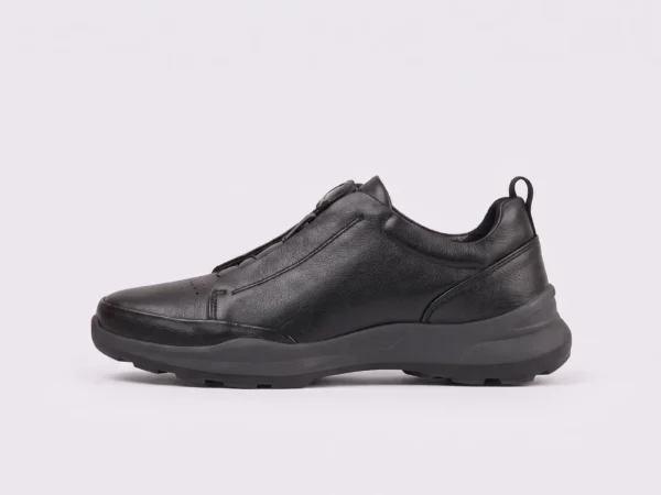 genuine leather business casual running sneakers in black, left side profile view on a light gray background