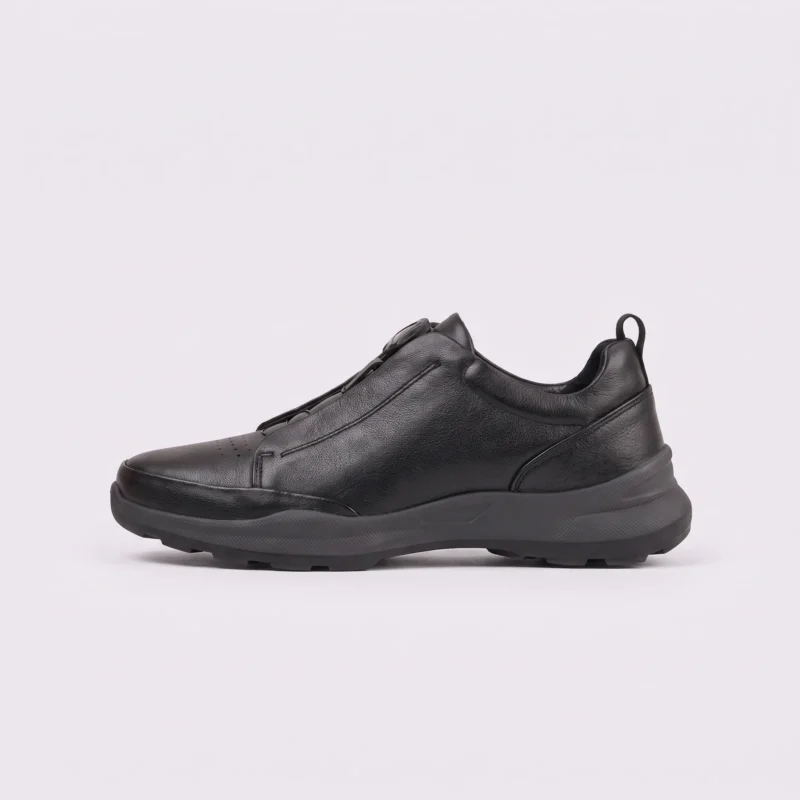 genuine leather business casual running sneakers in black, left side profile view on a light gray background
