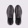 genuine leather business casual running sneakers in black, top-down view of the pair on a light gray background