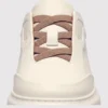 genuine leather platform sneakers, close-up view of the closure on a light gray background