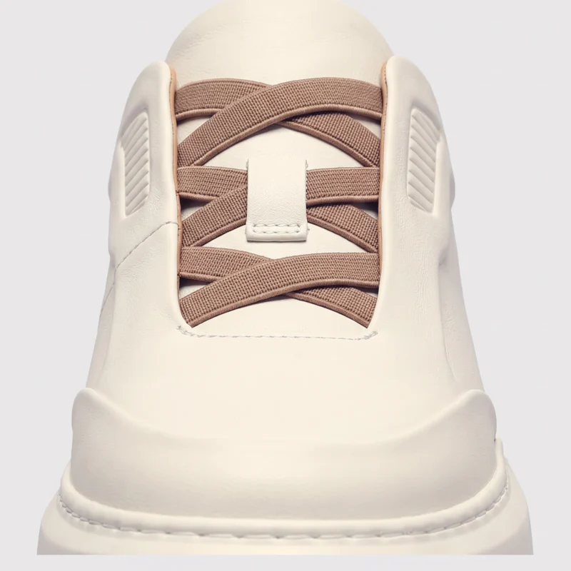 genuine leather platform sneakers, close-up view of the closure on a light gray background