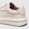 genuine leather platform sneakers, close-up view of the heel on a light gray background