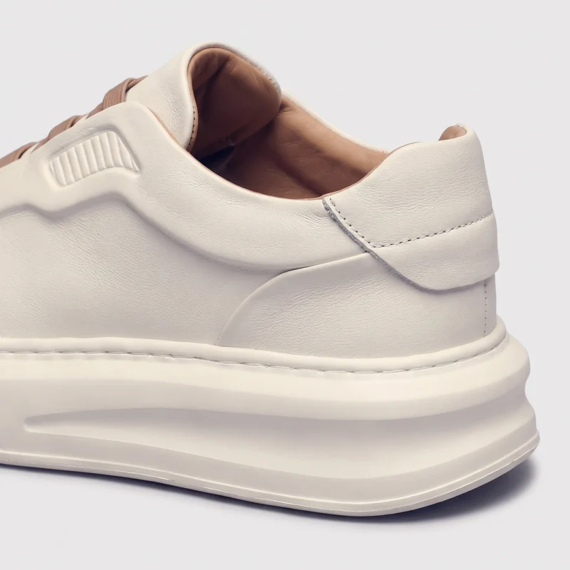 genuine leather platform sneakers, close-up view of the heel on a light gray background
