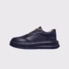 genuine leather platform sneakers in black, left side profile view on a light gray background