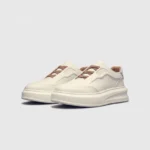 genuine leather platform sneakers in white, front 45-degree view of the pair on a light gray background