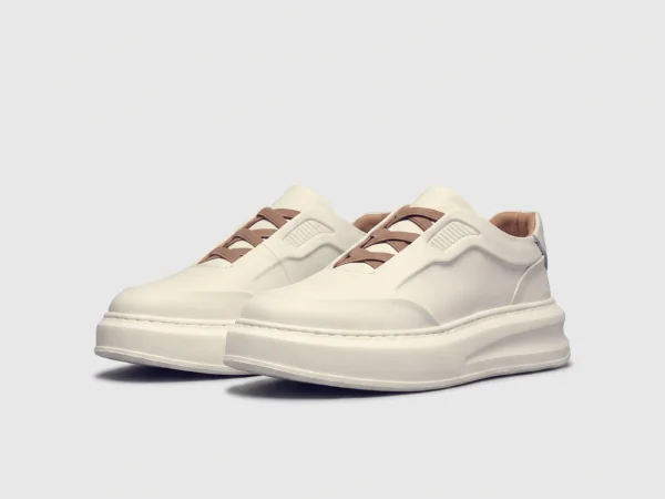 genuine leather platform sneakers in white, front 45-degree view of the pair on a light gray background