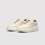 genuine leather platform sneakers in white, front 45-degree view of the pair on a light gray background