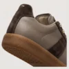 retro platform german trainer sneakers in brown, close-up view of the heel on a light gray background