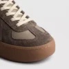 retro platform german trainer sneakers in brown, close-up view of the toe on a light gray background