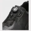 genuine leather rotating dial casual sneakers breathable lightweight in black, close-up view of the closure on a light gray background