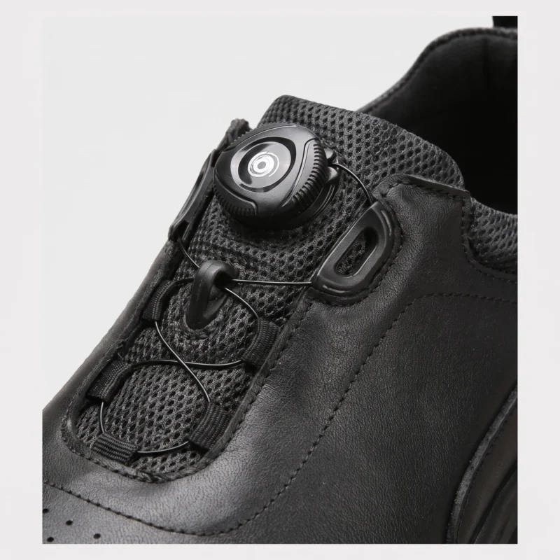 genuine leather rotating dial casual sneakers breathable lightweight in black, close-up view of the closure on a light gray background