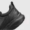 genuine leather rotating dial casual sneakers breathable lightweight in black, close-up view of the heel on a light gray background