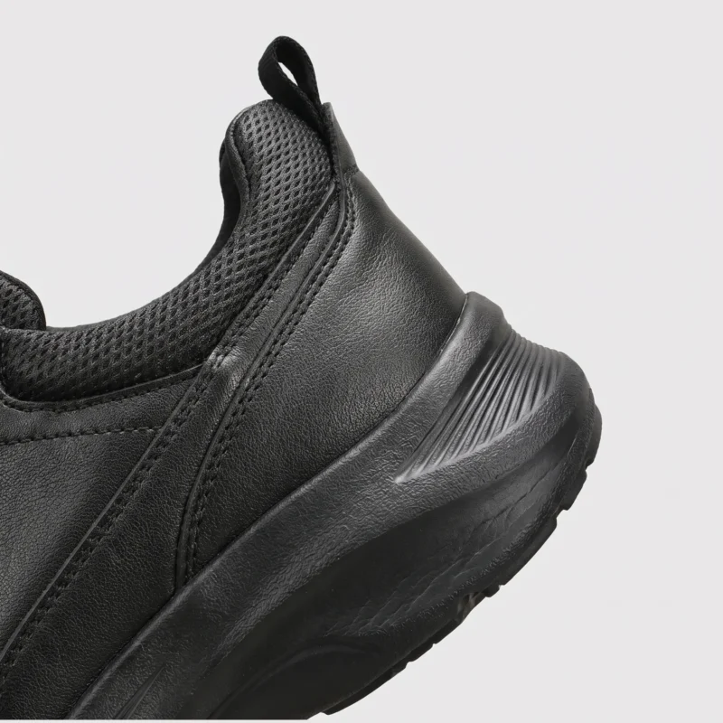 genuine leather rotating dial casual sneakers breathable lightweight in black, close-up view of the heel on a light gray background