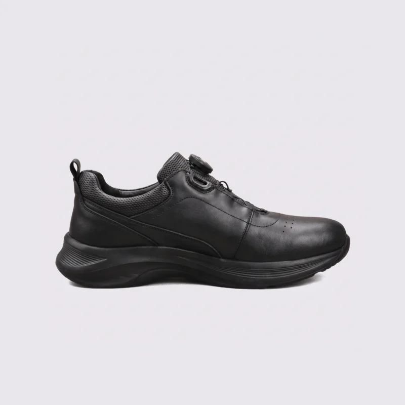 genuine leather rotating dial casual sneakers breathable lightweight in black, left side profile view on a light gray background