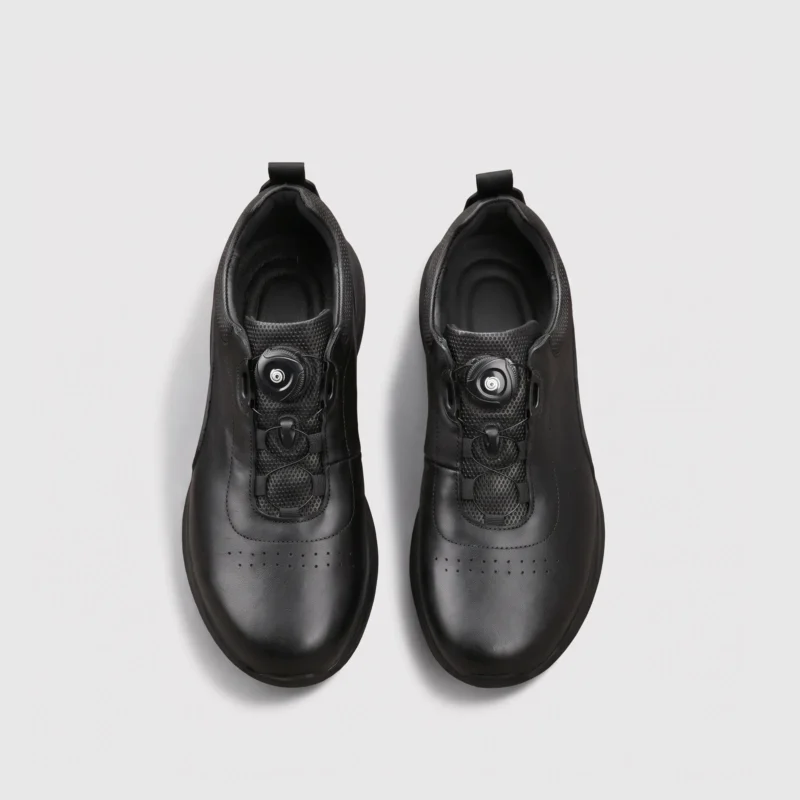 genuine leather rotating dial casual sneakers breathable lightweight in black, top-down view of the pair on a light gray background