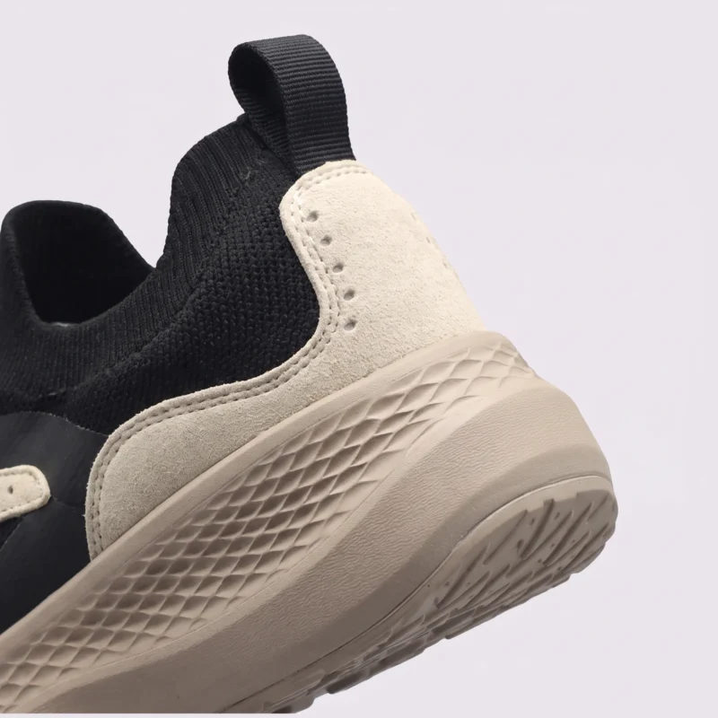 slip-on breathable running sneakers lightweight cushioned casual shoes in khaki, close-up view of the heel on a light gray background