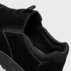 slip-on work safety shoes lightweight suede anti-slip driving shoes in black, close-up view of the closure on a light gray background