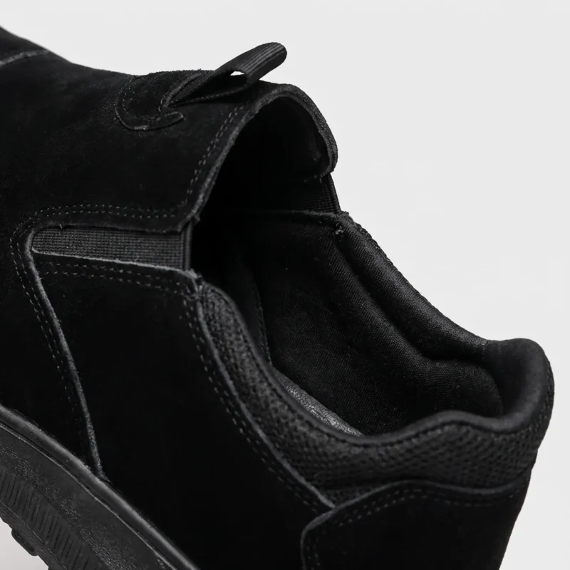 slip-on work safety shoes lightweight suede anti-slip driving shoes in black, close-up view of the closure on a light gray background