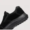slip-on work safety shoes lightweight suede anti-slip driving shoes in black, close-up view of the heel on a light gray background