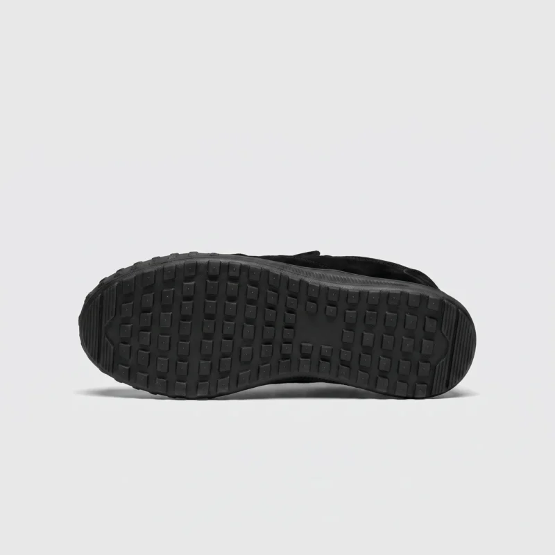 slip-on work safety shoes lightweight suede anti-slip driving shoes in black, outsole tread view on a light gray background