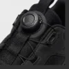 trendy rotating dial closure casual sneakers breathable chunky sole commuter shoes in black, close-up view of the closure on a light gray background