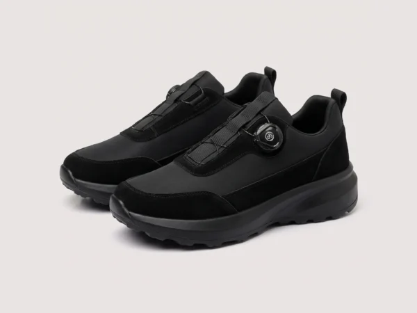 trendy rotating dial closure casual sneakers breathable chunky sole commuter shoes in black, front 45-degree view of the pair on a light gray background