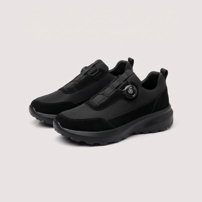trendy rotating dial closure casual sneakers breathable chunky sole commuter shoes in black, front 45-degree view of the pair on a light gray background