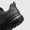 trendy rotating dial closure casual sneakers breathable chunky sole commuter shoes in black, close-up view of the heel on a light gray background